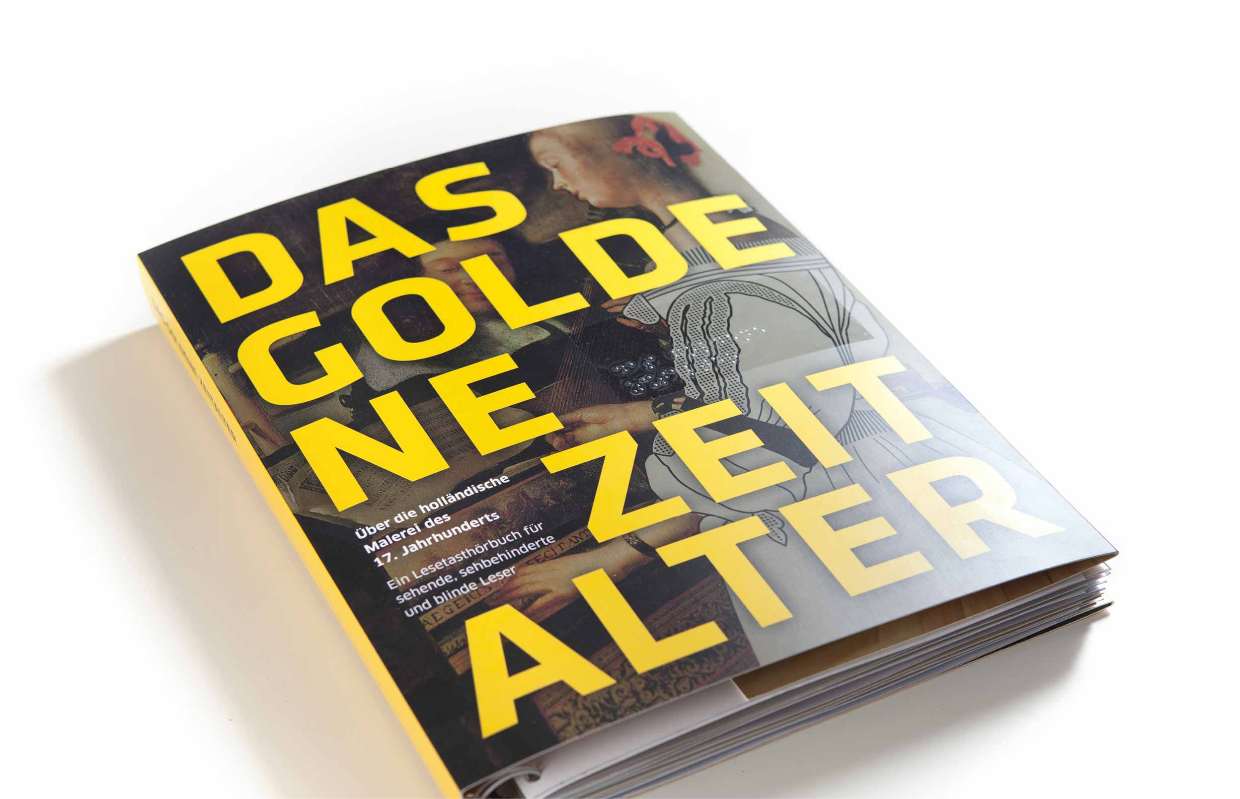View of the title of the closed book lying on a white background. The title shows in the background, blurred and dark, a detail of the painting "Lady at the Harpsichord". On it, in large sun-yellow letters, the title of the book: The Golden Age, which is also applied in Braille with the help of a sticker.