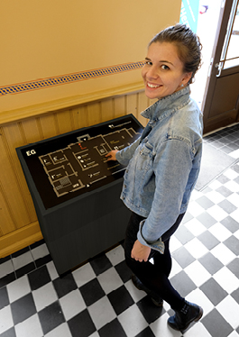 Photo of a visitor at the tactile map in the entrance area of the Bürgerbahnhof