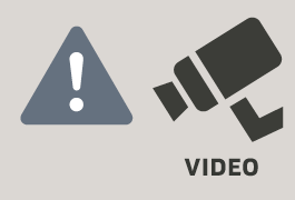 Piktogramm, das über Videoüberwachung informiert: ein weißes Ausrufezeichen auf einem dunkelgrauen Dreieck, rechts daneben eine stilisierte Videokamera und der Schriftzug „Video“