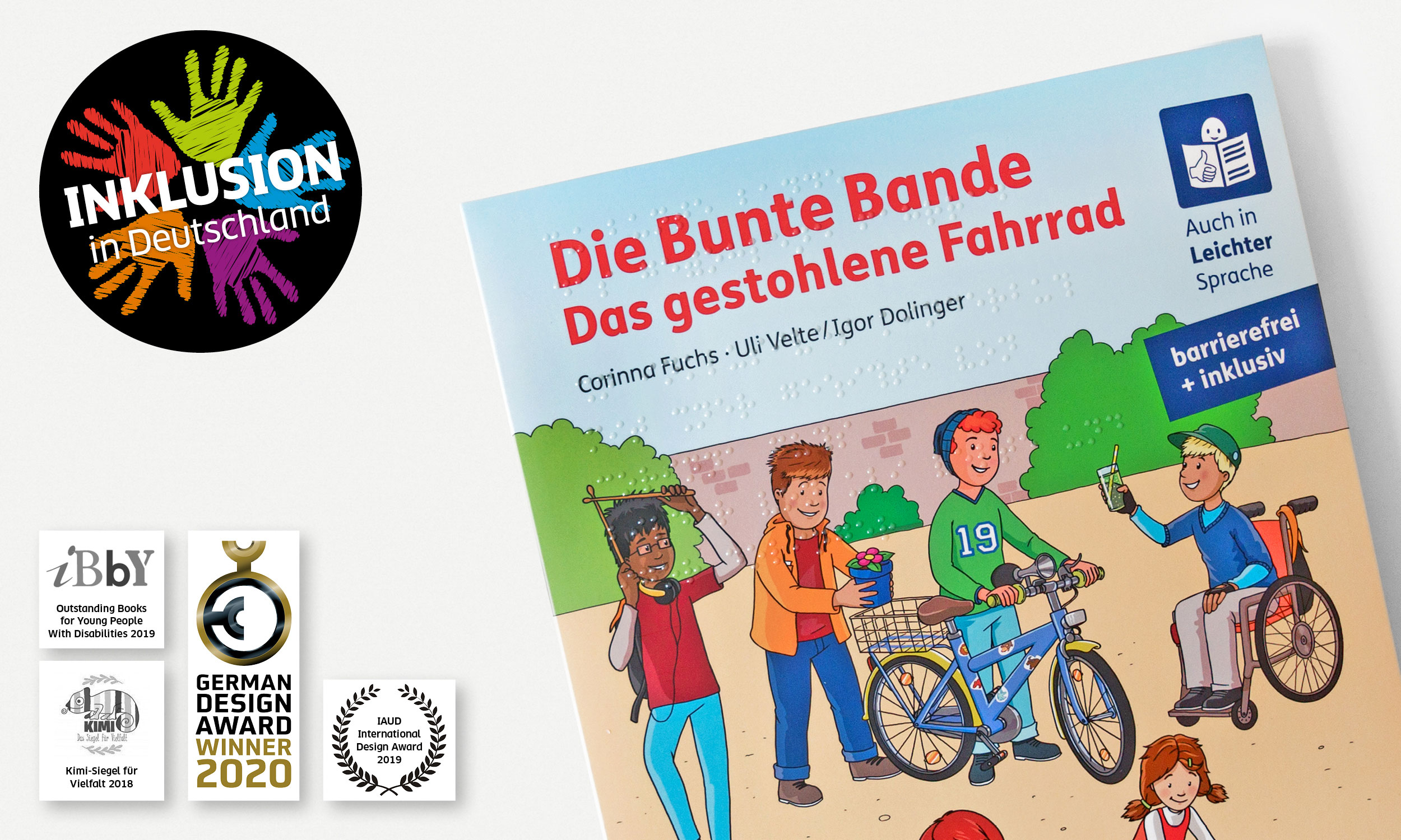 Cover of the book "Die Bunte Bande, Das gestohlene Fahrrad". In the upper left corner of the picture a black circular sticker. In it, 5 colourful hands are visible. On it is written in large white letters: \"Inclusion in Germany\". In the lower left corner the seals of the prizes for the Bunte Bande