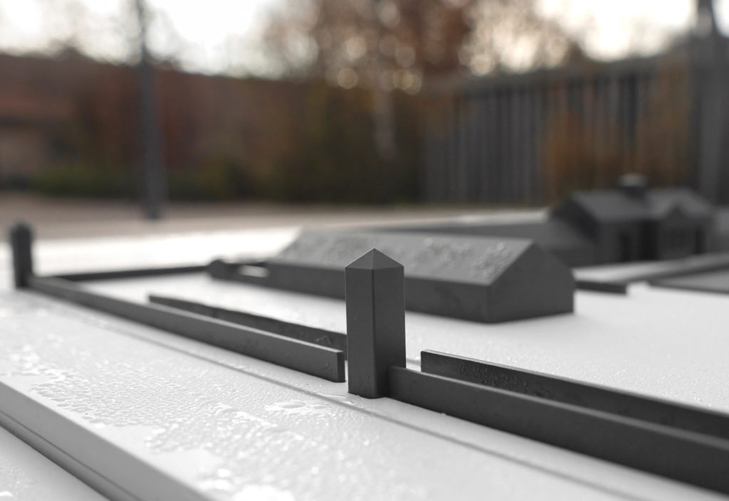 Detail photo of a tactile model with guard towers of the concentration camp in the foreground