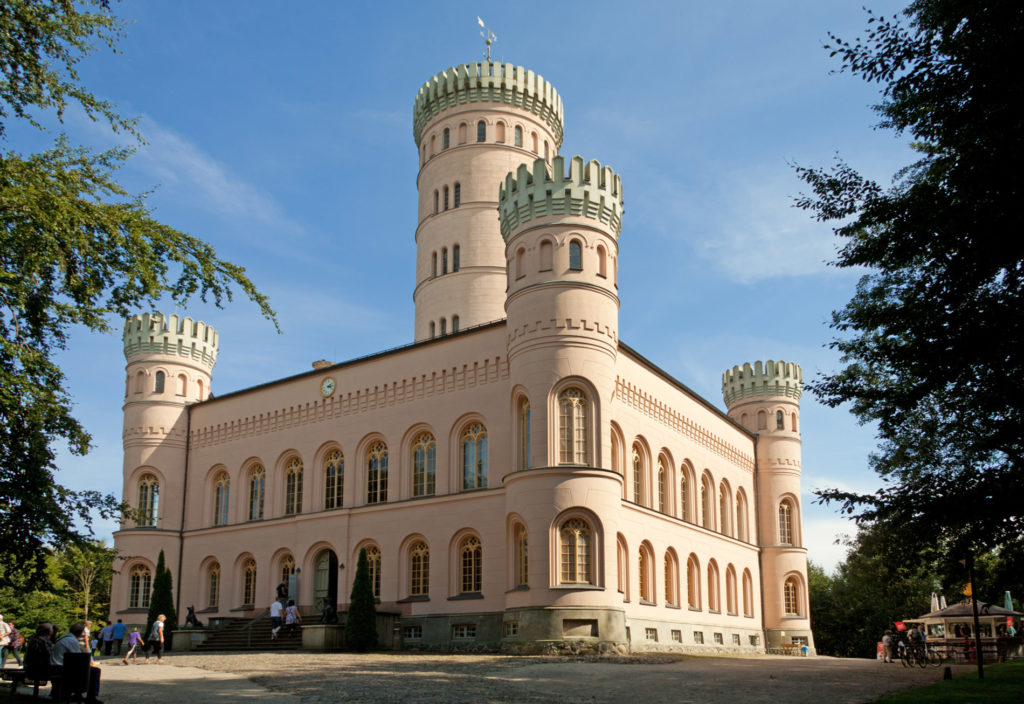 Photo with exterior view of the Granitz hunting lodge, built in 1846 by the Putbus family. It is built in the style of northern Italian Renaissance castels with four corner towers and an imposing central tower.