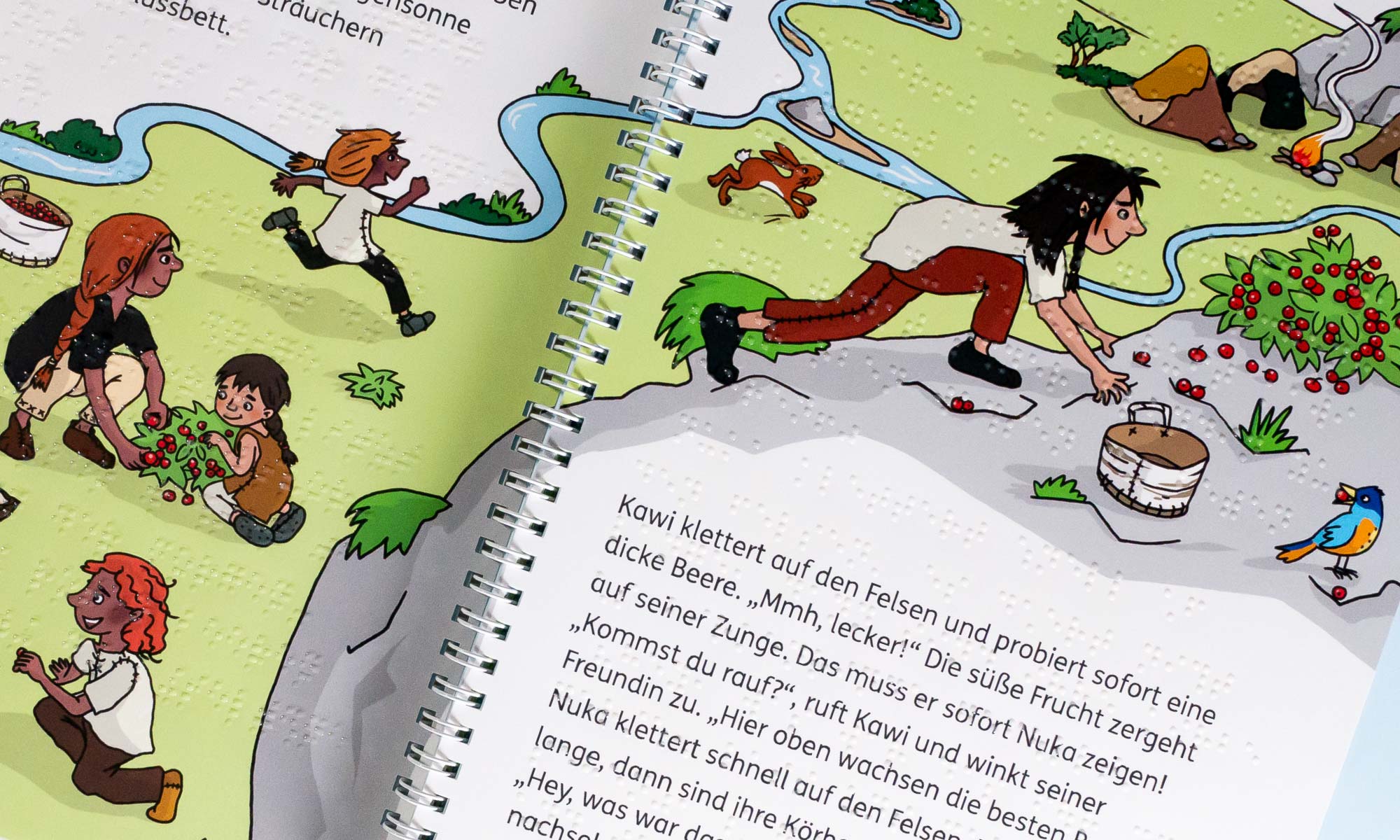 Close-up of a page of the book. There is a large illustration over two pages. It shows different children collecting berries. In the middle is a white spiral bound. Again, black print and braille are combined.